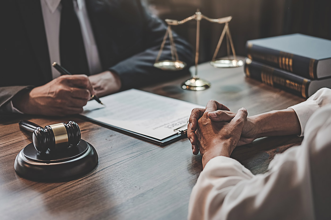 Lawyer and client having a conversation and signing documents