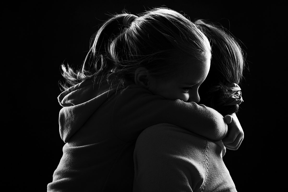 Daughter giving her mother a tight hug